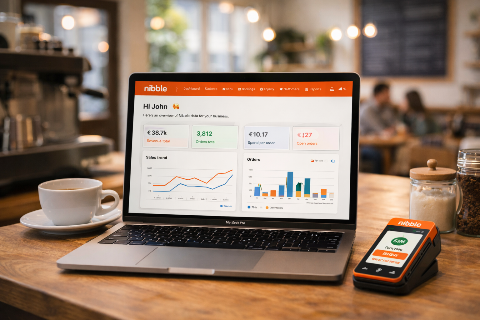 NibbleOS dashboard on a laptop showing revenue charts and order stats, with a Stripe payment terminal alongside
