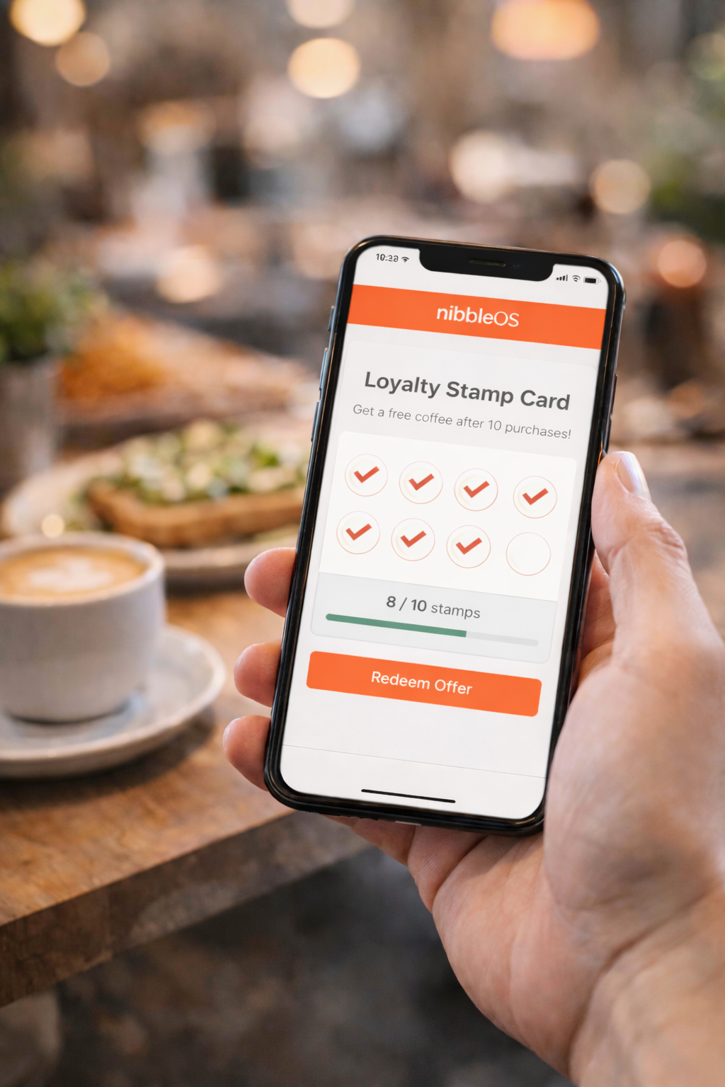 Customer holding a phone showing a NibbleOS digital loyalty stamp card with stamps collected in a cafe